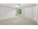 Spacious bedroom featuring a large window, neutral walls, carpet and a closet at 2920 Cushing Ct, Jonesboro, GA 30236
