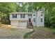 Charming two-story home with a two-car garage and a welcoming front entrance with wooden stairs at 2920 Cushing Ct, Jonesboro, GA 30236