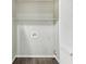 The laundry room features wood-look floors, hookups, and wire shelving at 2920 Cushing Ct, Jonesboro, GA 30236