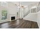 Bright and airy living room featuring a cozy fireplace, hardwood floors, and ample natural light from large windows at 2920 Cushing Ct, Jonesboro, GA 30236