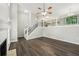Open-concept living area with a fireplace, hardwood floors, and staircase views to the upper level at 2920 Cushing Ct, Jonesboro, GA 30236