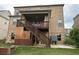 Large brick house with a covered porch with stairs leading down to the backyard space at 4933 Greenard Watson Ln, Buford, GA 30518