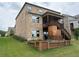 Two story home showcasing a backyard with a wooden deck with stairs and lush green grass at 4933 Greenard Watson Ln, Buford, GA 30518
