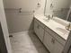 Bathroom with a double sink vanity, tiled floors, and contemporary fixtures at 4933 Greenard Watson Ln, Buford, GA 30518