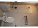 Well-lit bathroom features a toilet, towel rack and shower with marble tile at 4933 Greenard Watson Ln, Buford, GA 30518