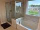 Bright bathroom with a glass-enclosed shower and separate tub with a view at 4933 Greenard Watson Ln, Buford, GA 30518