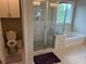 Bathroom with a glass-enclosed shower, separate tub, and toilet at 4933 Greenard Watson Ln, Buford, GA 30518
