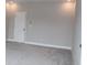 Bright empty room features neutral colored walls, carpet flooring, and a door on the far wall at 4933 Greenard Watson Ln, Buford, GA 30518