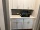 Cozy counter area showcasing a built-in aquarium and clean white cabinetry at 4933 Greenard Watson Ln, Buford, GA 30518