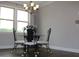 Wrought iron table and chairs in a dining area with natural light and neutral color palette at 4933 Greenard Watson Ln, Buford, GA 30518