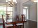Bright dining room features a chandelier, large windows, and elegant wood furnishings at 4933 Greenard Watson Ln, Buford, GA 30518