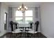 Dining room includes view through window, ornate wrought iron chairs and chandelier at 4933 Greenard Watson Ln, Buford, GA 30518