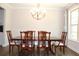 Spacious dining room with wooden chairs, large table, and modern chandelier at 4933 Greenard Watson Ln, Buford, GA 30518