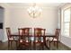 Dining room showcases a classic chandelier, natural light, and a stylish wooden dining set at 4933 Greenard Watson Ln, Buford, GA 30518