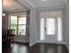 Bright entryway with white door, transom window and elegant curtains allows natural light at 4933 Greenard Watson Ln, Buford, GA 30518
