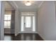 Inviting entryway with transom window and stylish sheer curtains allows natural light into the home at 4933 Greenard Watson Ln, Buford, GA 30518