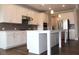 Bright kitchen featuring white cabinets, stainless steel appliances, and a spacious island at 4933 Greenard Watson Ln, Buford, GA 30518