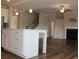 View of the kitchen island and appliances open to the Gathering room with fireplace at 4933 Greenard Watson Ln, Buford, GA 30518