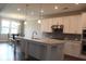 Well-lit kitchen showcasing white cabinets, stainless steel appliances, and a functional island with a sink at 4933 Greenard Watson Ln, Buford, GA 30518