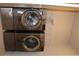 Modern stacked washer and dryer set with stainless steel finish in laundry closet at 4933 Greenard Watson Ln, Buford, GA 30518
