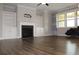 Spacious living room showcases a fireplace, built-in shelving, and large windows creating a welcoming atmosphere at 4933 Greenard Watson Ln, Buford, GA 30518