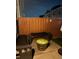 Evening shot of a cozy backyard patio, lit by a festive glowing fire barrel at 5008 Whiteoak Pointe Se # 15, Smyrna, GA 30080
