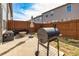 Private backyard patio with a grill, seating, wooden fence, and outdoor umbrella at 5008 Whiteoak Pointe Se # 15, Smyrna, GA 30080