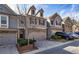 Beautiful townhome with brick details, two-car garage, tidy landscaping, and stylish curb appeal at 5008 Whiteoak Pointe Se # 15, Smyrna, GA 30080