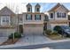 Charming townhome with neutral siding, brick accents, two-car garage, and manicured landscaping at 5008 Whiteoak Pointe Se # 15, Smyrna, GA 30080