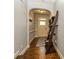 Inviting hallway featuring hardwood floors, neutral walls, arched doorway, and stylish decor at 5008 Whiteoak Pointe Se # 15, Smyrna, GA 30080