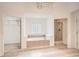 Bathroom features soaking tub, glass enclosed shower, closet and bright lighting at 1873 Jameson Cir, Lawrenceville, GA 30043