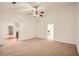 Spacious bedroom with neutral carpet, vaulted ceilings, ceiling fan and double door entry at 1873 Jameson Cir, Lawrenceville, GA 30043