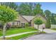 Charming brick home featuring a well-manicured lawn and a two-car garage at 1873 Jameson Cir, Lawrenceville, GA 30043