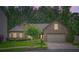 Charming brick home at dusk featuring a well-manicured lawn and a two-car garage at 1873 Jameson Cir, Lawrenceville, GA 30043