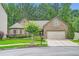 Charming brick home featuring a well-manicured lawn and a two-car garage at 1873 Jameson Cir, Lawrenceville, GA 30043