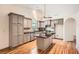 Bright kitchen features grey cabinets, granite countertops, hardwood flooring and stainless steel appliances at 1873 Jameson Cir, Lawrenceville, GA 30043