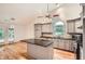 Bright kitchen with grey cabinets, granite countertops, hardwood flooring and stainless steel appliances at 1873 Jameson Cir, Lawrenceville, GA 30043