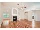 Open living room featuring hardwood floors, fireplace, and views into other living spaces at 1873 Jameson Cir, Lawrenceville, GA 30043