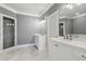 Bathroom featuring marble floors, dual vanities, a stand-up shower, and a soaking tub at 2362 Saint Davids Nw Sq, Kennesaw, GA 30152