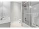 Bathroom with a shower and bath tub combination featuring glass doors and a white vanity at 2362 Saint Davids Nw Sq, Kennesaw, GA 30152