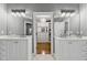 Bathroom suite featuring dual vanities, granite countertops, and an entry into the walk-in closet at 2362 Saint Davids Nw Sq, Kennesaw, GA 30152