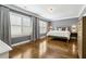 Spacious bedroom featuring hardwood floors, gray walls, white trim, and ample natural light at 2362 Saint Davids Nw Sq, Kennesaw, GA 30152