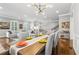 Well-lit dining room with modern light fixture and hardwood floors, open to the staircase and living room at 2362 Saint Davids Nw Sq, Kennesaw, GA 30152