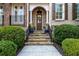Inviting entryway with stone steps, wrought iron railing, and manicured greenery at 2362 Saint Davids Nw Sq, Kennesaw, GA 30152