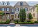 Brick townhome showcasing traditional architecture, well-maintained shrubs, and a welcoming entrance at 2362 Saint Davids Nw Sq, Kennesaw, GA 30152