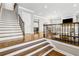 Bright foyer with hardwood floors, staircase with iron railing, and open floor plan at 2362 Saint Davids Nw Sq, Kennesaw, GA 30152