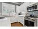 Modern kitchen with white cabinets, stainless steel appliances, and island with bar seating at 2362 Saint Davids Nw Sq, Kennesaw, GA 30152