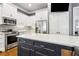 Open kitchen featuring an island with seating, stainless appliances, and white cabinets at 2362 Saint Davids Nw Sq, Kennesaw, GA 30152