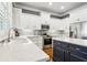 Kitchen with white cabinets, stainless steel appliances, and an island with dark-stained wood at 2362 Saint Davids Nw Sq, Kennesaw, GA 30152
