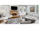 Cozy living room showcasing a stone fireplace, plush seating, and bright windows at 2362 Saint Davids Nw Sq, Kennesaw, GA 30152